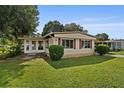 Cozy home featuring a sunroom addition at 2060 Lamplight Cir, Mount Dora, FL 32757
