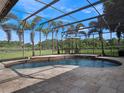 Inviting screened-in pool area with stone decking, ideal for outdoor relaxation and entertainment at 2106 Ridgewind Way, Windermere, FL 34786