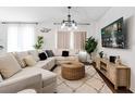Bright living room featuring a sectional sofa, area rug, and a mounted television at 2363 Lancashire St, Davenport, FL 33896