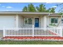 Charming home featuring a white picket fence, well-maintained lawn, and inviting entrance at 2871 Milstead St, Orlando, FL 32837