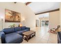 Spacious living room boasts a high ceiling with wood beams, tile flooring, and ample natural light at 2871 Milstead St, Orlando, FL 32837