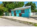 Brightly painted single-story home with metal roof and gravel landscaping at 318 Palm St, New Smyrna Beach, FL 32168