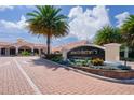 Beautiful community entrance with lush landscaping, stately signage and brick pavers at 346 David Walker Dr # K-6, Tavares, FL 32778
