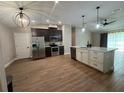 Open kitchen with stainless steel appliances, dark cabinetry, and a large island at 358 2Nd St, Geneva, FL 32732