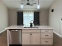Modern kitchen island featuring a stainless steel dishwasher and a light countertop at 358 2Nd St, Geneva, FL 32732