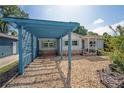 Quaint single-Gathering home featuring neutral siding, stone accents, and a detached blue carport at 3637 Dubsdread Cir, Orlando, FL 32804