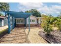 Quaint single-Gathering home featuring neutral siding, stone accents, and a detached blue carport at 3637 Dubsdread Cir, Orlando, FL 32804