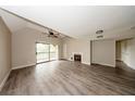 Spacious living room boasting vaulted ceiling, ceiling fan, fireplace and wood-look floors, with balcony access at 420 Forestway Cir # 306, Altamonte Springs, FL 32701