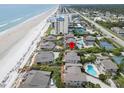 Aerial view of homes with direct beach access, a pool, and blue ocean at 4365 S Atlantic Ave # B8, New Smyrna Beach, FL 32169