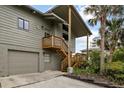 Exterior view of the home with a garage and stairs leading to the entrance at 4365 S Atlantic Ave # B8, New Smyrna Beach, FL 32169
