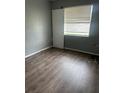 Cozy bedroom with wood flooring and ample natural light from a large window at 4402 King Cole Blvd, Orlando, FL 32811
