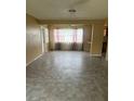 Open-concept living room featuring durable flooring, and space for dining near the kitchen bar at 4402 King Cole Blvd, Orlando, FL 32811