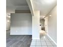 Open-concept living area with carpet flooring, gray walls and white trim, transitioning to tiled hallway at 468 Rio Grande Ct, Kissimmee, FL 34759