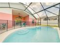 Screened-in pool with covered lanai and steps into the water offering a delightful backyard retreat at 4700 Prairie Point Blvd, Kissimmee, FL 34746