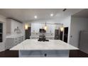 Elegant kitchen with quartz countertops, stainless appliances and modern lighting fixtures at 4760 Ohio Ave, Sanford, FL 32771