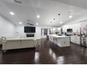 Open-concept living room and kitchen featuring modern finishes and a cozy fireplace at 4760 Ohio Ave, Sanford, FL 32771