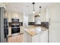 Bright kitchen featuring stainless appliances, tile backsplash and granite countertops at 478 Chicago Woods Cir, Orlando, FL 32824