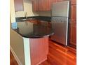 The kitchen includes wooden floors and stainless steel refrigerator at 4830 S Conway Rd # 40, Orlando, FL 32812