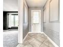 Elegant entryway with tiled floors and paneled walls, leading to a spacious living area at 4993 Southlawn Ave, Orlando, FL 32811