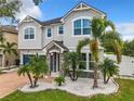 Inviting two-story home with well-manicured front yard, featuring lush landscaping and a stone-accented entrance at 4993 Southlawn Ave, Orlando, FL 32811