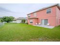 Expansive backyard featuring a well-maintained lawn and a quaint patio perfect for outdoor entertaining at 547 Brighton Ct, Kissimmee, FL 34758