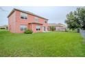 Spacious backyard, fully fenced, features lush green grass and ample room for recreation and relaxation at 547 Brighton Ct, Kissimmee, FL 34758