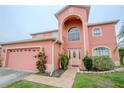 Charming two-story home with landscaped yard, a two car garage, and beautiful front door at 547 Brighton Ct, Kissimmee, FL 34758