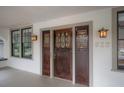 Close up of the front door with sidelights and vintage hardware, plus address and exterior lights at 622 S Ingraham Ave, Lakeland, FL 33801