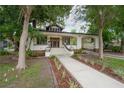 Charming vintage home featuring a welcoming front porch, landscaped yard, and attached carport at 622 S Ingraham Ave, Lakeland, FL 33801
