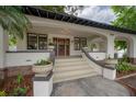 Charming front porch with steps and large planters, offering a welcoming entrance to the home at 622 S Ingraham Ave, Lakeland, FL 33801