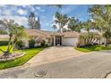 Beautiful single-story home featuring a tile roof and well-manicured landscaping at 625 Nighthawk Cir, Winter Springs, FL 32708