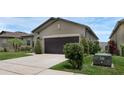 Well-maintained home featuring a two-car garage, a concrete driveway and manicured shrubs and landscaping at 8615 N Rindge Rd, Polk City, FL 33868
