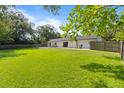 Spacious backyard with lush green grass and a privacy fence, perfect for outdoor activities at 897 Shed St, Oviedo, FL 32765