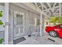 Welcoming entrance with a screened door, complemented by a covered carport for convenient parking and protection from the elements at 906 25Th Nw St, Winter Haven, FL 33881