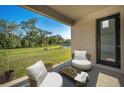 A serene patio featuring comfortable seating and a view of the lush green lawn at 9199 Waverly Walk Dr, Orlando, FL 32817