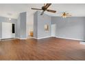 Open living space with hardwood flooring, ceiling fans and neutral walls at 9833 Tattersall Ave, Orlando, FL 32817