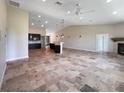 Bright, open living space with tile floors, recessed lighting, and views into the kitchen and dining area at 10170 Se 106Th Ln, Belleview, FL 34420