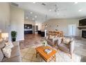 Inviting open-concept living room featuring tile floors, a ceiling fan, and a cozy seating arrangement at 10170 Se 106Th Ln, Belleview, FL 34420