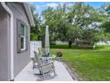 Relaxing outdoor patio with rocking chairs and table, perfect for enjoying the serene backyard at 1020 Taproot Dr, Winter Springs, FL 32708