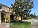 A row of townhomes featuring well-manicured lawns and lush trees along the street at 11187 Savannah Landing Cir, Orlando, FL 32832