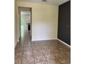 View of spacious living room featuring neutral walls and floors, and a glimpse of the kitchen at 11187 Savannah Landing Cir, Orlando, FL 32832