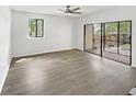 Spacious living room with wood-look flooring, natural light, and access to outdoor patio at 1404 Oak Pl # A, Apopka, FL 32712
