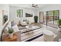 Bright living room featuring a modern rug, stylish furniture, and large sliding glass doors to the patio at 1404 Oak Pl # A, Apopka, FL 32712