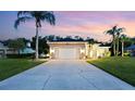 Charming home with a spacious driveway, a well-maintained lawn, and tropical landscaping at 1907 Sir Lancelot Cir, St Cloud, FL 34772