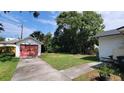 Spacious backyard featuring a detached garage, mature trees and plenty of room for outdoor activities at 206 N Highland Ave, Winter Garden, FL 34787
