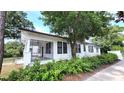 Vintage home featuring a screened-in porch, mature landscaping and classic architectural details at 206 N Highland Ave, Winter Garden, FL 34787