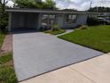 Inviting single-story home with a covered carport and beautifully landscaped yard at 2103 Mantilla Ave, Orlando, FL 32811