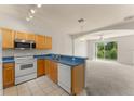 Functional kitchen with breakfast bar, and full appliances. Includes a great view of the living room space at 214 Monroe Cir, Davenport, FL 33896