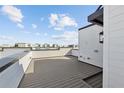 Spacious rooftop patio with bright white siding under blue sky, perfect for relaxing and entertaining at 2318 Addalia Aly, Orlando, FL 32804