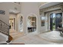 Elegant foyer featuring tile flooring, arched entryways, and custom wood details that lead to the living spaces at 2357 Alaqua Dr, Longwood, FL 32779